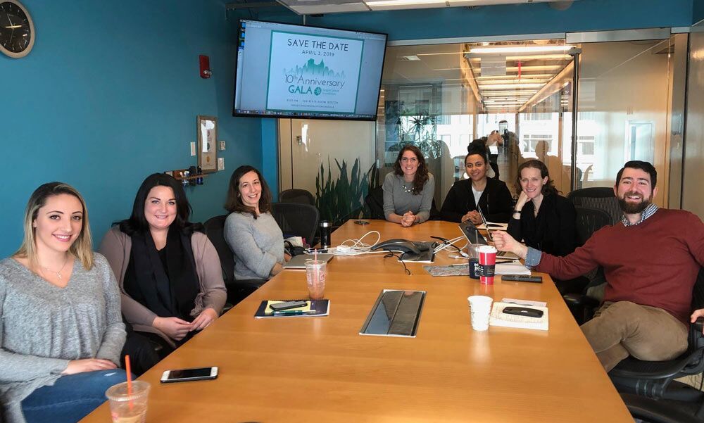 TCF Volunteers sitting around a conference table during a planning session