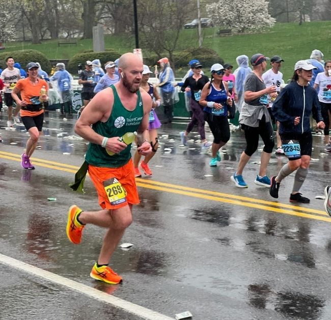 Colin Carey running in the Boston Marathon with Team TCF