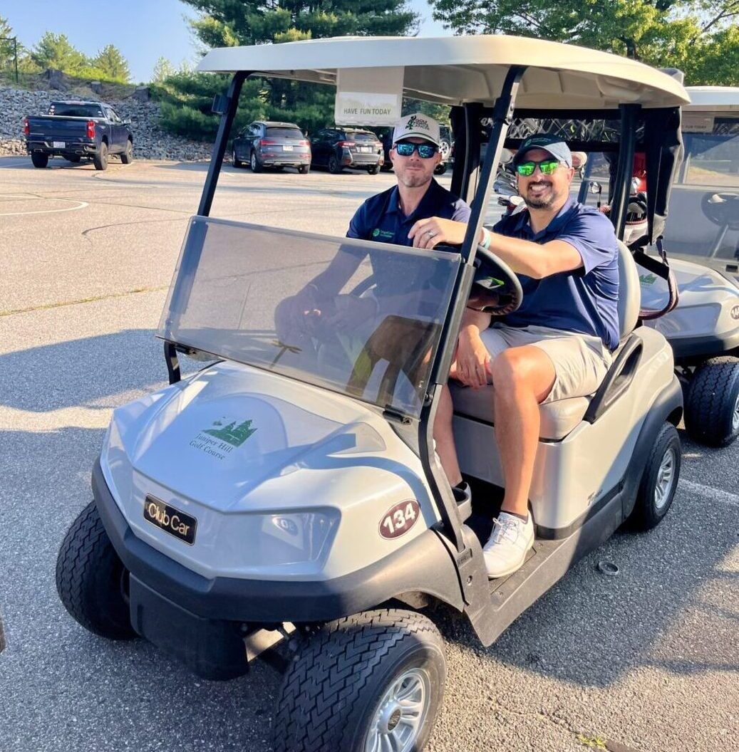 Colin and Ryan in golf cart and golf marathon